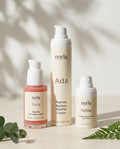 Norla Full Ritual Peptide Trio: Vera peptide serum, Ada AM/PM cream and Nellie eye cream on a marble surface with eucalyptus and fern