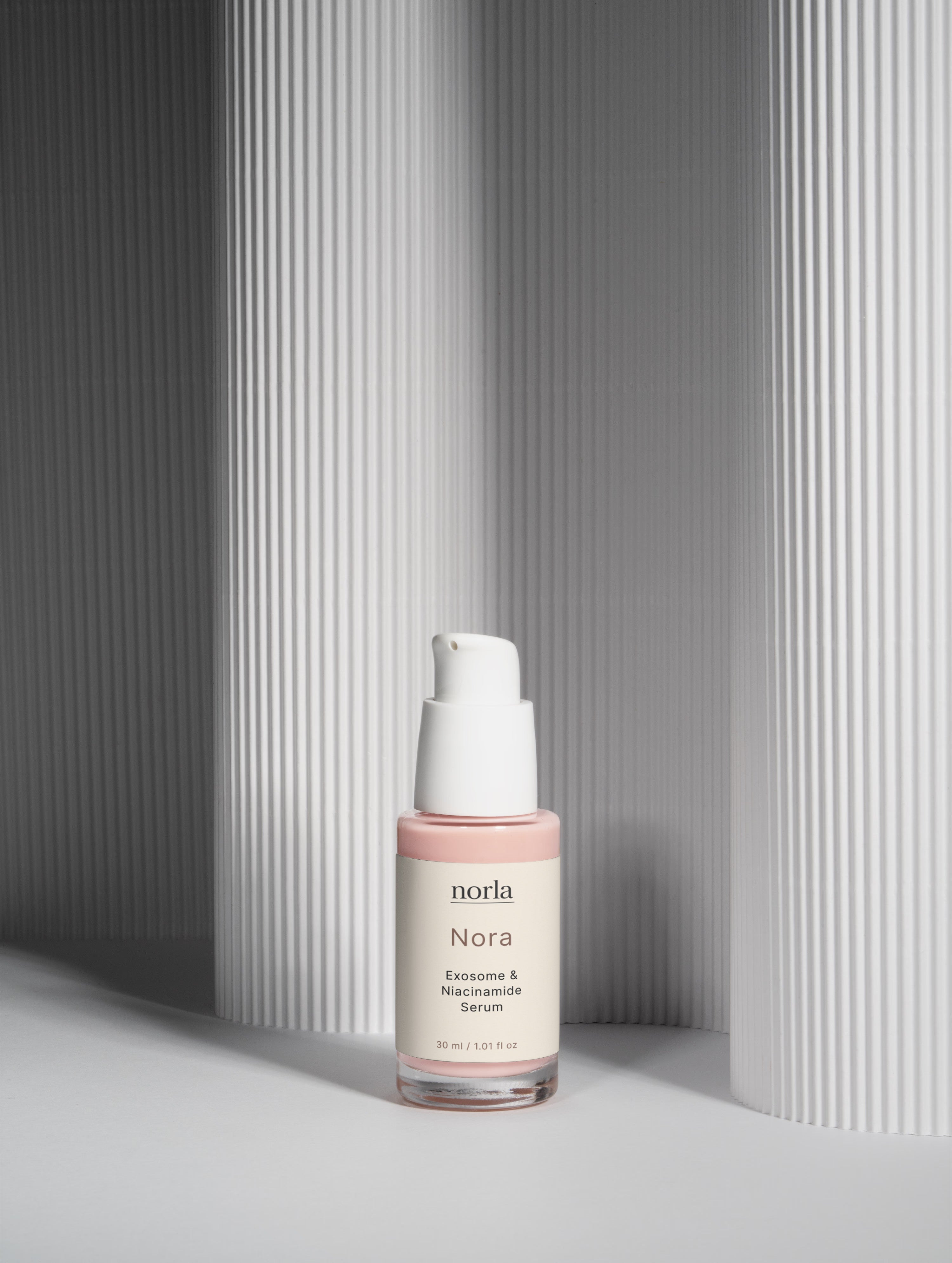 Nora — Exosome & Niacinamide Serum by Norla against a soft fluted backdrop